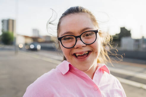 Happy teenage girl with down syndrome wearing eyeglasses - MEUF07412