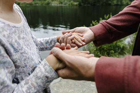 Vater hält die Hand seiner Tochter im Park - TYF00359