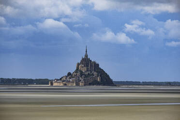 Le Mont Saint Michel, UNESCO World Heritage Site, at low tide on a sunny day with some white clouds, Normandy, France, Europe - RHPLF22621