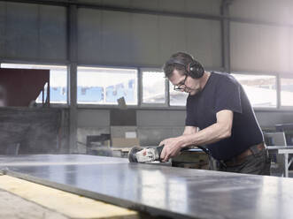 Stonemason cutting marble slab with grinder at workshop - CVF02079