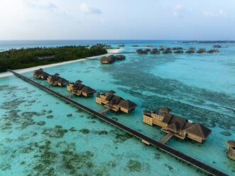 Maldives, North Male Atoll, Lankanfushi, Aerial view of bungalows of tropical tourist resort - AMF09560