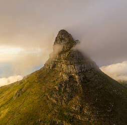 Aerial View of Table Mountain peak shrouded in clouds at sunset, Signal Hill Nature Reserve, Cape Town, Western Cape, South Africa. - AAEF15214