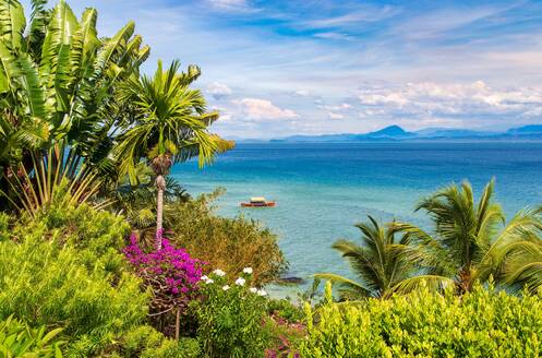 Boat seen through lush vegetation at Nosy Komba Island in the North West of Madagascar, Indian Ocean, Africa - RHPLF22714