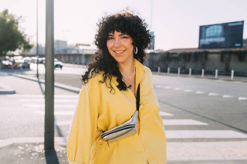 Smiling woman standing on street a sunny day - MEUF07477