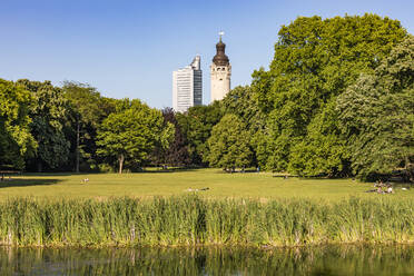 Germany, Saxony, Leipzig, Lakeshore in Johannapark with green trees in background - WDF06982
