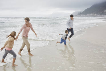 Parents running on the beach with children - RORF03030