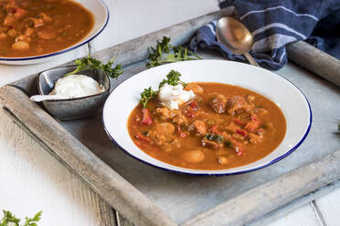 Schale mit verzehrfertiger Soljanka-Suppe mit saurer Sahne und Petersilie - SBDF04549