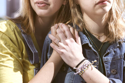 Young friends with holding hands on sunny day - KMKF01879