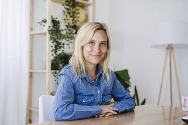 Smiling blond businesswoman at desk in home office - EBBF05766