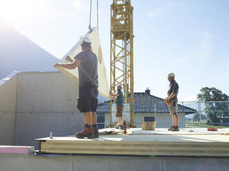Carpenters working at construction site on sunny day - CVF02123