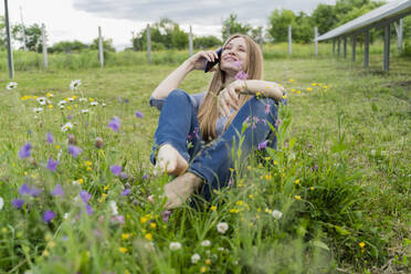 Happy engineer talking on smart phone at field - OSF00674