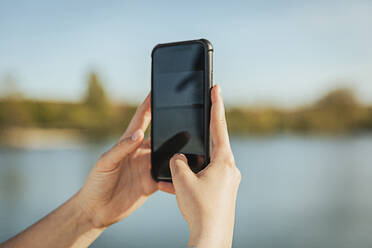 Woman's hand photographing on mobile phone - ACPF01445