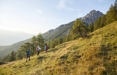 Backpackers climbing mountain on sunny day, Mutters, Tyrol, Austria - CVF02163