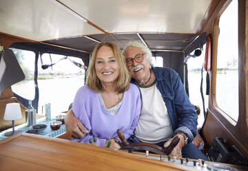 Happy senior couple enjoying in boat - RHF02611