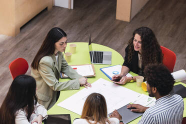 Business team having a meeting at table in conference room discussing floor plan - PNAF04409