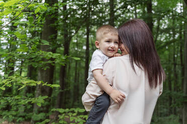 Happy mother and son in forest on vacation - OSF00703