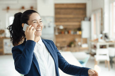 Happy businesswoman talking on mobile phone - JOSEF11937