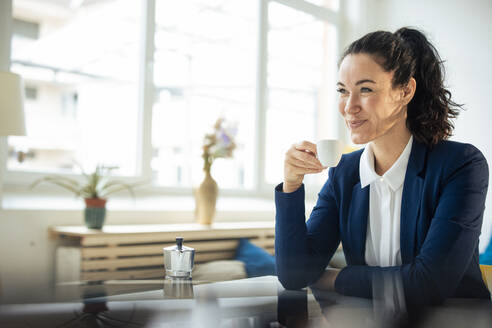 Happy businesswoman holding coffee cup - JOSEF11940