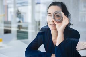 Businesswoman looking through ring shape object - JOSEF11986