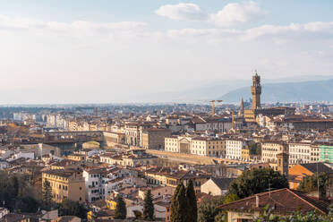 Italy, Tuscany, Florence, Residential district with bell tower of Palazzo Vecchio in background - TAMF03473