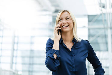 Smiling businesswoman talking on mobile phone - DIGF18715