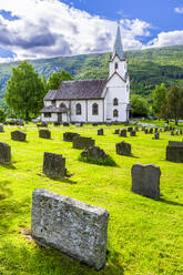 Norway, Viken, Torpo, Cemetery tombstones with rural church in background - STSF03457