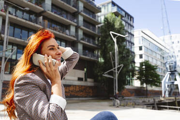 Happy redhead woman talking on smart phone - IHF01151