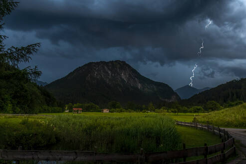 Germany, Bavaria, Oberstdorf, Thunderstorm over Stillachtal at dusk - FRF00968
