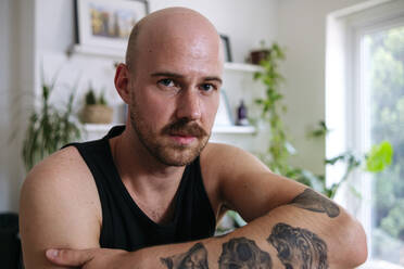 Man with mustache and tattoo at home - ASGF02731