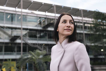 Mature businesswoman outside office building exterior - AMWF00396