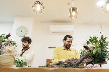 Floristen arrangieren Blumen im Geschäft - MRRF02396