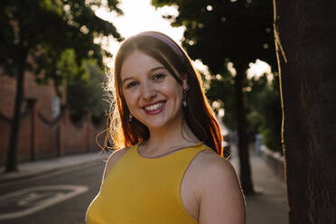 Smiling young woman with long hair at sunset - AMWF00577