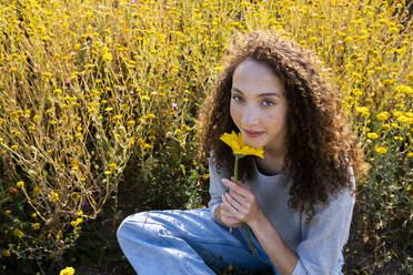 Young woman with flower in park - AMWF00605