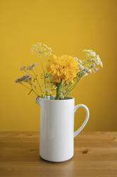 Flowers in white vase on table - LESF00056