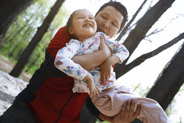 Father having fun with daughter in park - AZF00434