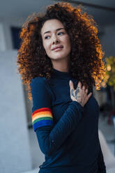 Smiling young woman with curly hair - JOSEF12899