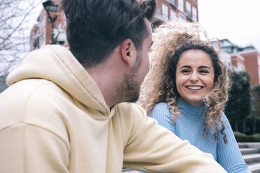 Happy young woman talking with boyfriend - AMWF00672