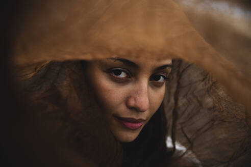 Confident young woman under brown scarf - MRAF00881