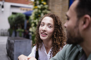 Smiling young woman talking with boyfriend - AMWF00753