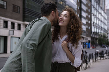 Man kissing woman on cheek at footpath - AMWF00772