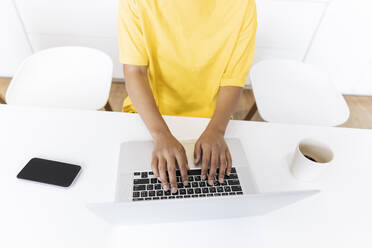 Hands of woman working on a computer in the kitchen - SIF00462