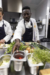 Chefs preparing food in kitchen of restaurant - MASF31568