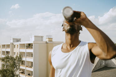 Young man drinking water during sunny sunny day - MASF31722