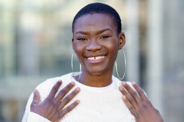 Happy woman wearing hoop earring - GGGF01186