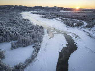 Aerial view of Kattilakoski Rapids in Winter during sunset in Norrbotten, Sweden. - AAEF15527