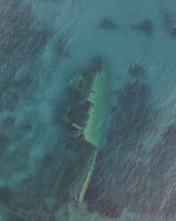 Aerial view of a sunken shipwreck near the rocks along the coast in Pomonte, Elba Island, Tuscany, Italy. - AAEF15742