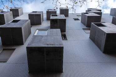 From below exterior of residential house with windows and various gray balconies located against cloudy sky on street of city - ADSF37463