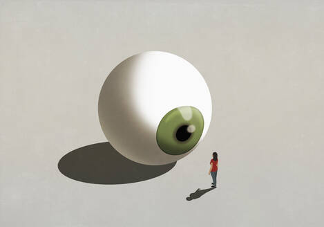 Woman standing at large green eyeball - FSIF06103