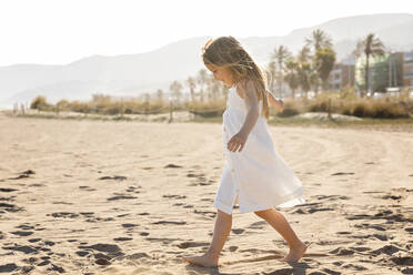 Girl with long hair walking at beach on sunny day - MEGF00068