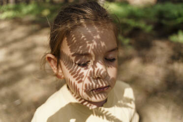 Fern leaves shadow on girl's face - TOF00083